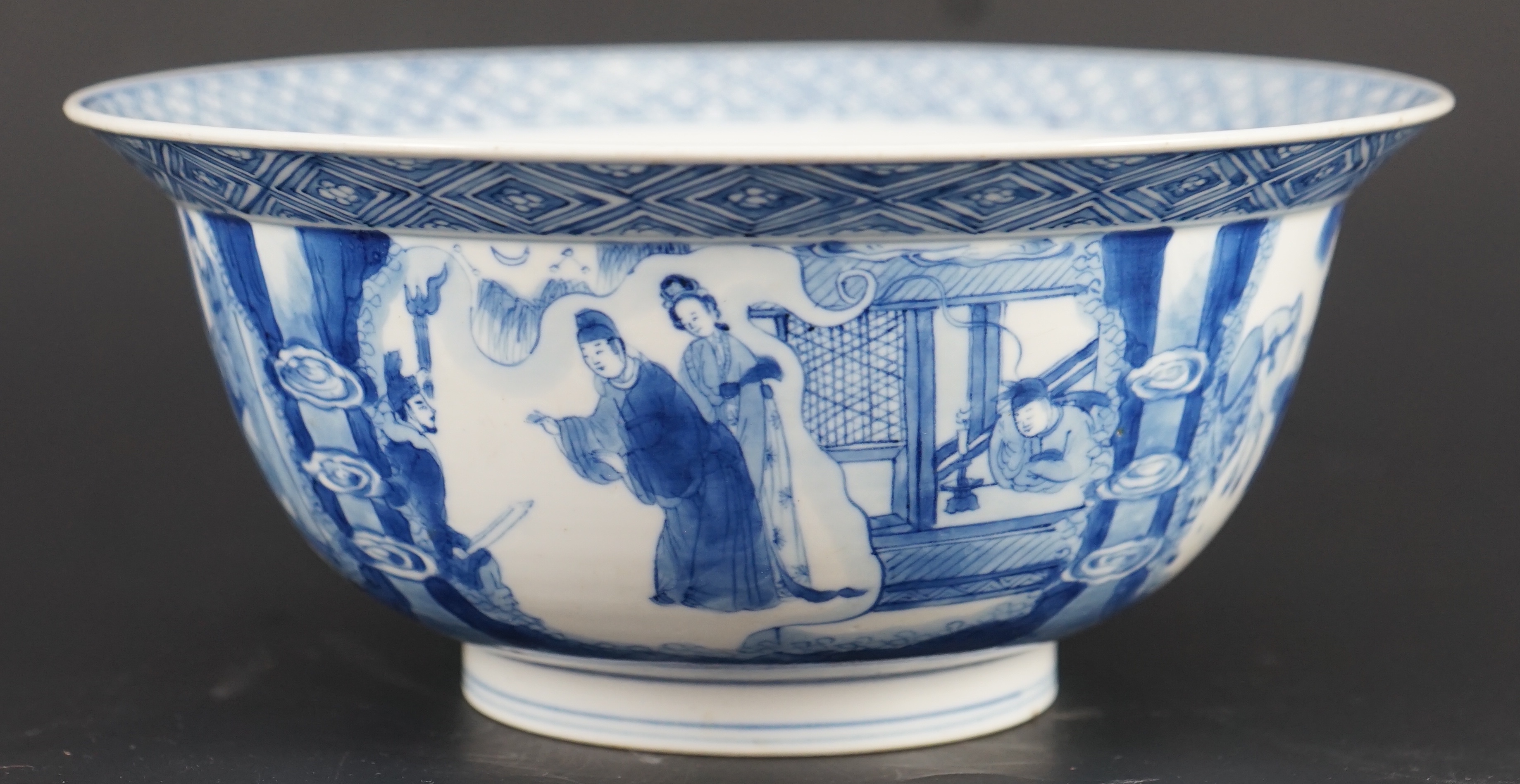 A fine Chinese blue and white ‘Xi Xiang Ji’ bowl, Kangxi six character mark and of the period (1662-1722) 19.9cm diameter, wood stand